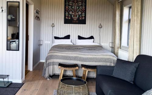 a bedroom with a bed and a couch at Áskot Cottages in Hella
