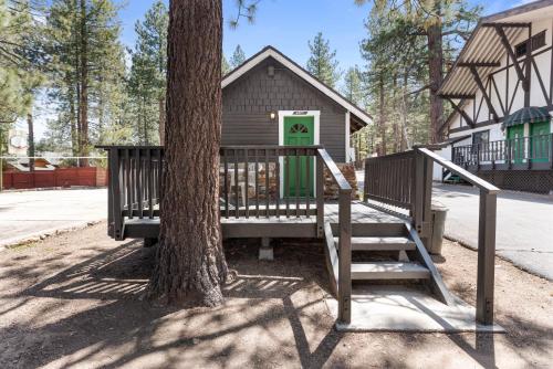 a house with a tree and a staircase leading to it at Black Forest Lodge in Big Bear Lake