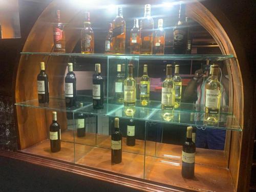 a display case filled with lots of bottles of wine at Sunrise Center Bonapriso - 107 in Douala