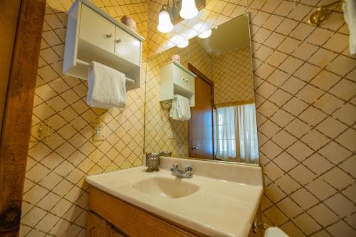 a bathroom with a sink and a mirror at Black Forest Lodge in Big Bear Lake