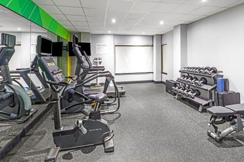 a gym with treadmills and elliptical machines at Holiday Inn Hotel & Suites Tulsa South by IHG in Tulsa