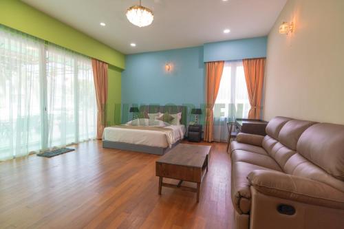 a living room with a couch and a bed at LuxegreenRetreat , Bungalow - Georgetown, Penang in George Town