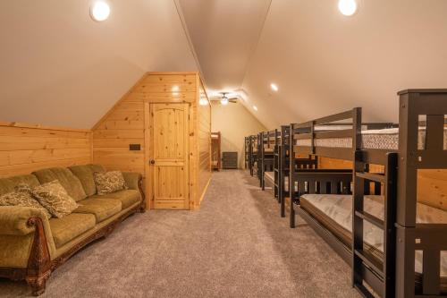 a room with a couch and several bunk beds at The Mountain Lodge in Elliottsburg