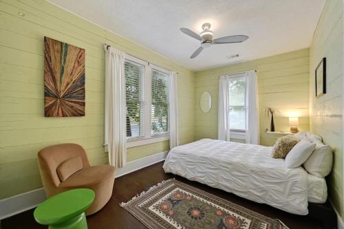 a bedroom with a bed and a chair and a window at Peaceful Bungalow with Fenced Yard near Shops and Cafes in Austin