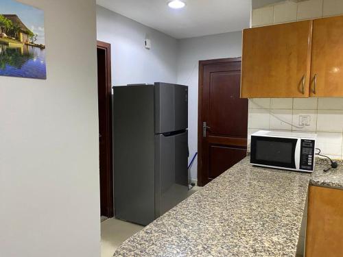 a kitchen with a refrigerator and a counter top at Solo Partition Room in Al Barsha 1 Near Mashreq Metro in Dubai