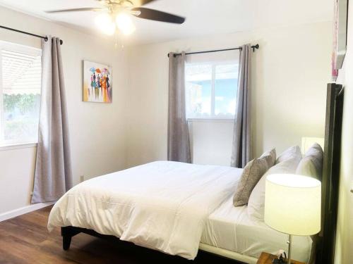 a bedroom with a white bed and a ceiling fan at 434-Campbell Cozy & Bright 2B/1b /AC/close to Downtown in Campbell