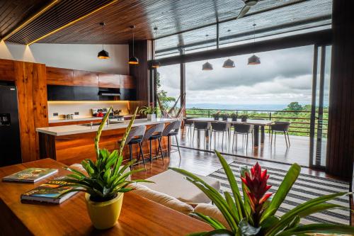 a kitchen and dining room with a view of the ocean at Ecolirios Boutique Hotel and Spa in Guácimo