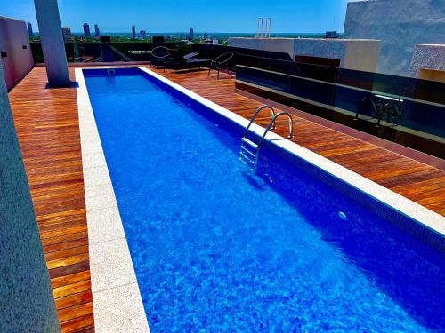 a swimming pool on the roof of a building at Los laureles towers in Asunción