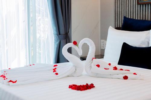 two swans made out of hearts on a bed at Hannah House Hoi An in Hoi An
