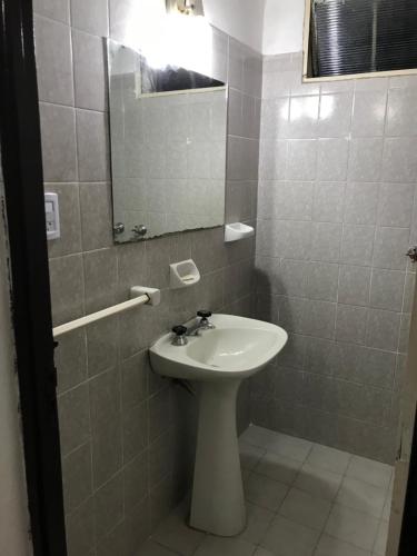 a bathroom with a sink and a mirror at departamento cucú in Villa Carlos Paz