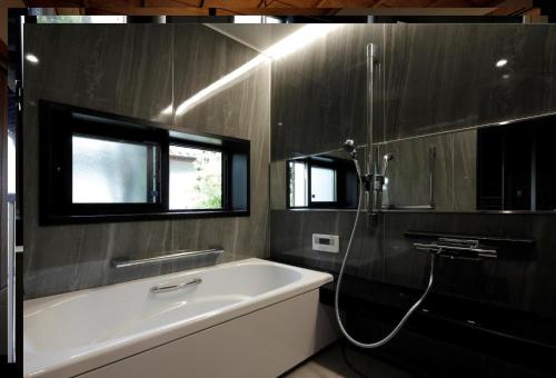 a bathroom with a bath tub and a shower at Kungin Bettei - Vacation STAY 14605 in Himeji