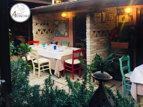 a dining room with a table and colorful chairs at LOCANDA LE 4 CIACOLE in Roverchiara
