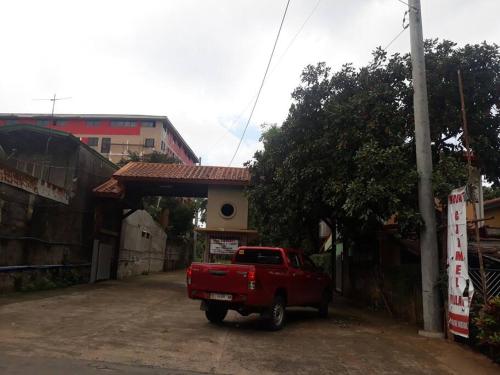 a red truck parked in front of a building at Cozy Condo Unit w/ FREE WIFI&Netflix-Pay Parking in Antipolo