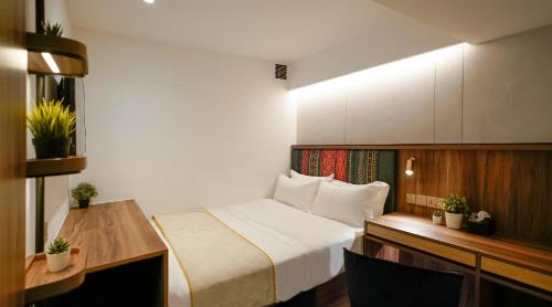 a hotel room with a bed and a desk at ST Signature Bugis Middle,DAYUSE,9 hours 9AM-6PM in Singapore