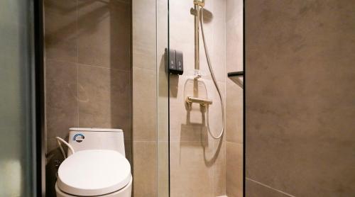 a bathroom with a toilet and a shower at ST Signature Bugis Middle,DAYUSE,9 hours 9AM-6PM in Singapore