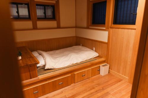 熊本的住宿－合い宿 くまもと，一间小型客房,设有一张位于桑拿浴室内的床铺