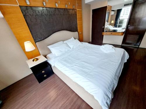 a large white bed in a room with a lamp at 7B-Short-term rental allowed-5BRs Downtown Bangkok in Makkasan