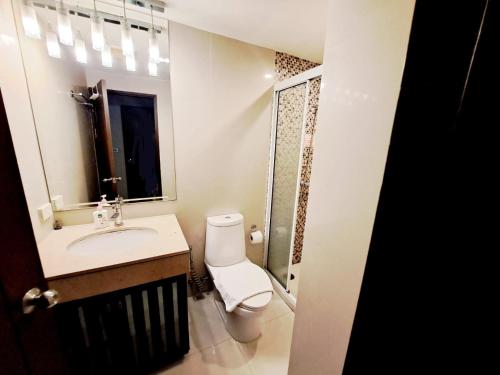 a bathroom with a toilet and a sink and a mirror at 7B-Short-term rental allowed-5BRs Downtown Bangkok in Makkasan
