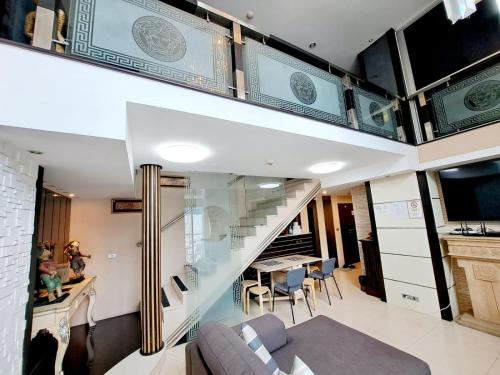 a living room with a staircase and a couch and a table at 7B-Short-term rental allowed-5BRs Downtown Bangkok in Makkasan