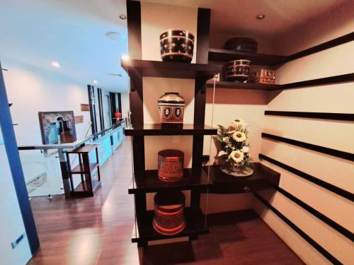 a room with a shelf with bowls and vases on it at 7B-Short-term rental allowed-5BRs Downtown Bangkok in Makkasan