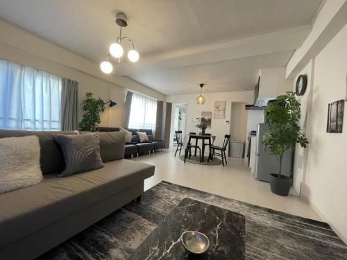 a living room with a couch and a table at Oak Stay Shimokitazawa Luxury Family size 2min Shimokitazawa sta Shinjuku Shibuya7min by train in Tokyo