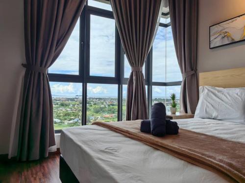 a bed with a stuffed animal sitting on it in front of a window at Near Airport K Avenue Family Room in Donggongon