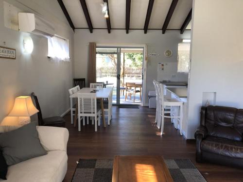a living room with a couch and a table at Stouty's at Hat Head - No Sheets or Towels Provided in Hat Head