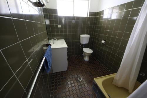 a small bathroom with a toilet and a sink at Stouty's at Hat Head in Hat Head