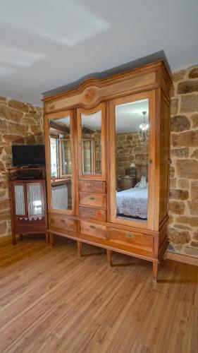a large wooden cabinet with a bed in a room at Posada Venta Hornizo in Arenas de Iguña