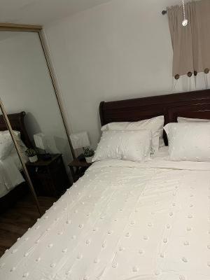 a bedroom with a bed with white sheets and pillows at Private Room in Rialto