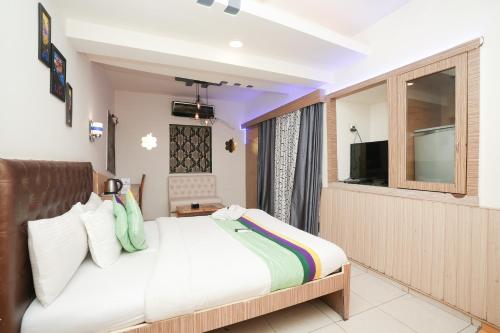a bedroom with a bed and a large window at Hotel Neelkiran in Navi Mumbai