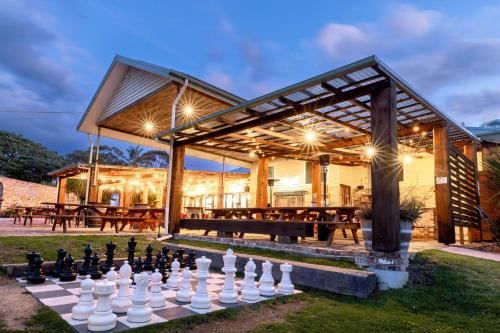 a chess board on the lawn in front of a house at BIG4 Wallaga Lake Holiday Park in Bermagui