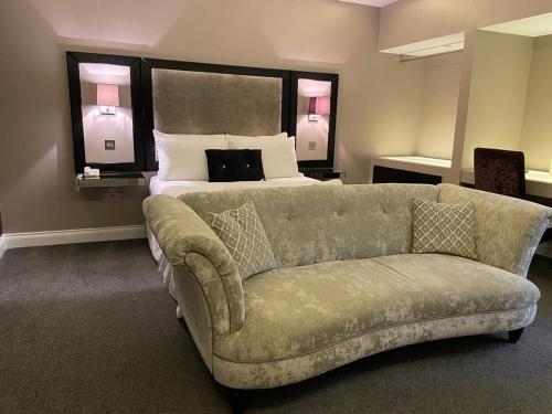 a living room with a couch and a bed at Limes hotel in Needham Market