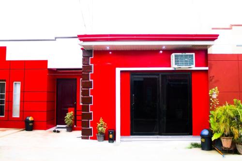 a red building with two doors and a window at RB Modern Condos in Zamboanga