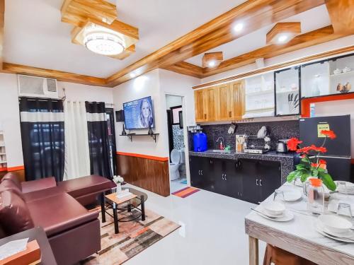 a kitchen and living room with a couch and a table at RB Modern Condos in Zamboanga