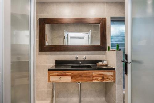 a bathroom with a sink and a mirror at A Perfect Stay - Brandon St Beach and Spa in Suffolk Park