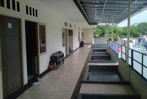 an empty hallway of a building with a row of windows at JAMMAN in Bandung
