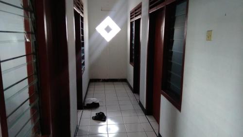 a hallway with a pair of shoes on the floor at JAMMAN in Bandung