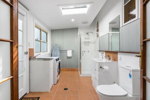a bathroom with a sink and a toilet at A Perfect Stay - Byron Surf Cottage in Byron Bay