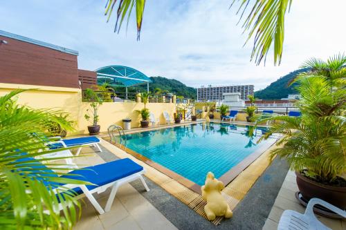 a pool on the roof of a building with plants at Thai Siam in Patong Beach