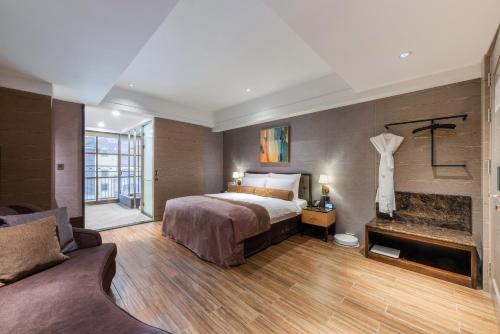 a hotel room with a bed and a fireplace at Grand Cosmos Resort Ruisui Hualien in Ruisui