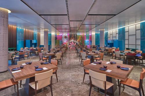 a rendering of a restaurant with tables and chairs at Aloft Singapore Novena in Singapore