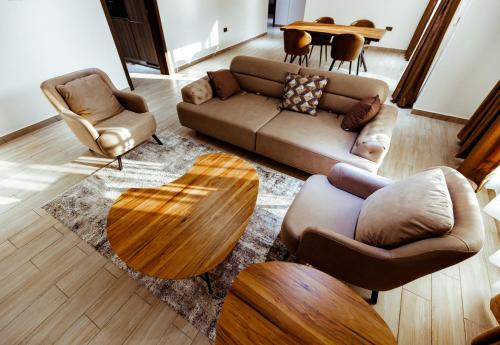 a living room with a couch and a table and chairs at Veronique Heights in Kumasi