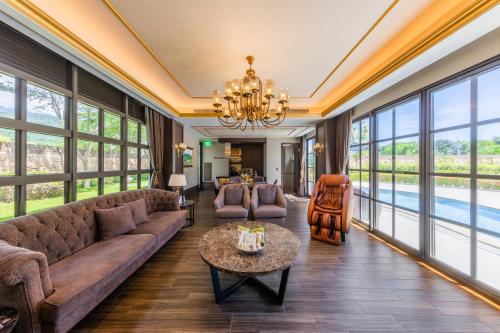 a living room filled with furniture and a chandelier at Grand Cosmos Resort Ruisui Hualien in Ruisui