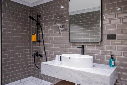 a bathroom with a sink and a shower at 南兜漫旅 in Tainan
