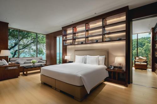 a bedroom with a large bed and a living room at Tonino Lamborghini Hotel Suzhou in Suzhou
