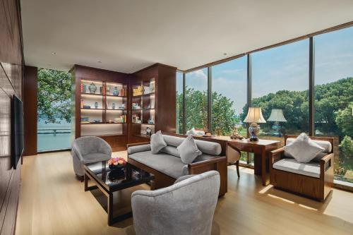 a living room filled with furniture and large windows at Tonino Lamborghini Hotel Suzhou in Suzhou