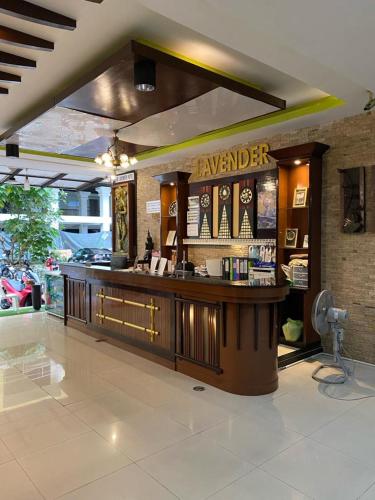a restaurant with a bar in the middle of a room at New Lavender Hotel Patong in Patong Beach
