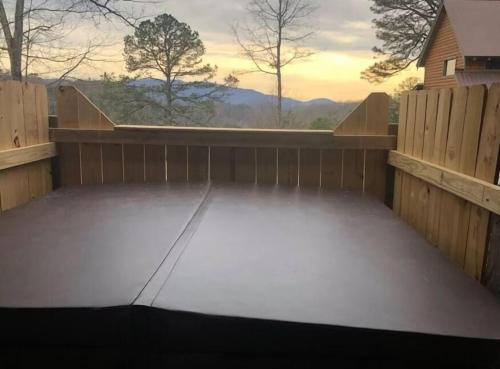 a screened in patio with a view of the mountains at Adelaide's Den cabin in Townsend