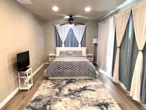 a bedroom with a bed and a flat screen tv at Cozy Room with Private bathroom & Entrance in Carson